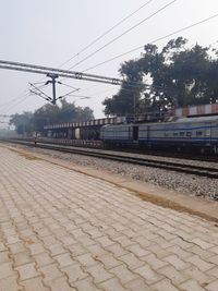 Train at railroad station against sky