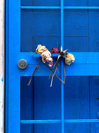 Flowers on blue door of building