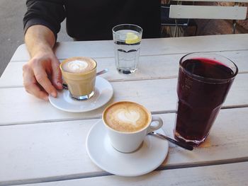 Close-up of man holding coffee cup
