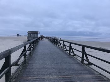 Pier over sea against sky