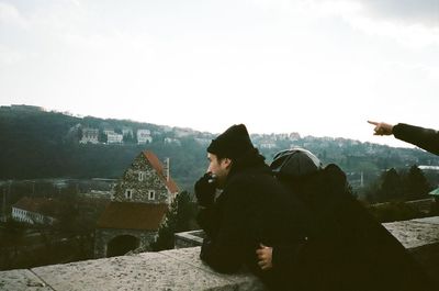 Rear view of man and woman against sky