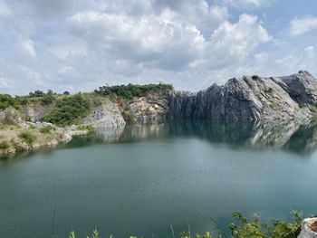 Scenic view of lake by trees against sky