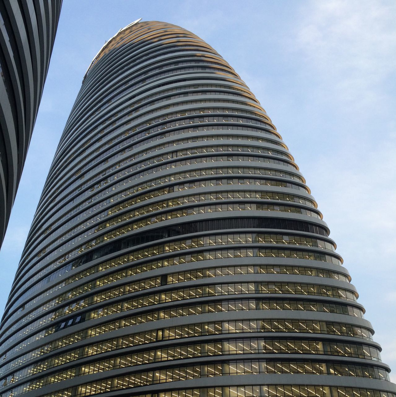 architecture, low angle view, built structure, building exterior, modern, skyscraper, office building, tall - high, city, sky, tower, building, tall, no people, outdoors, repetition, day, pattern, architectural feature, glass - material