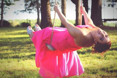 Woman swinging on grassy field