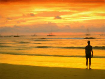 Silhouette of man standing on beach