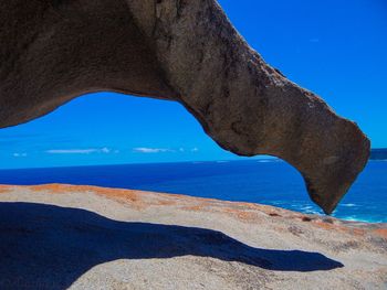 Scenic view of beach against blue sky