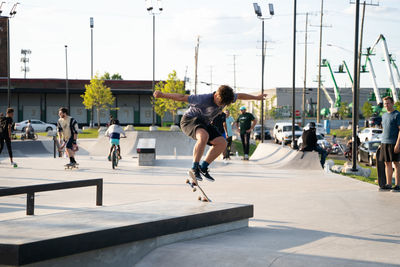 Group of people skateboarding in city