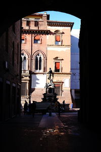 Statue by historic building in city