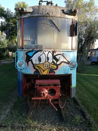 Close-up of truck on field against sky