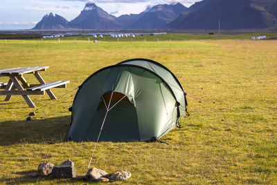 Tent on field against mountain