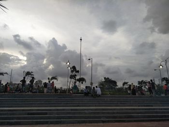 People on street against sky