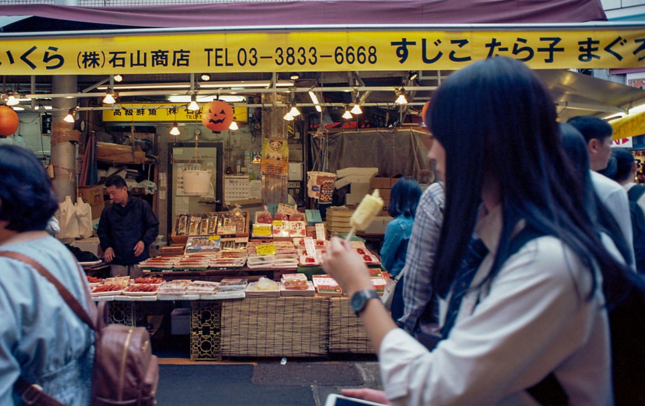 group of people, women, food and drink, adult, real people, men, food, business, crowd, restaurant, lifestyles, people, leisure activity, table, eating, sitting, market, city, text, concession stand, dining, consumerism