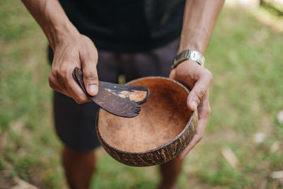 Midsection of man holding eating utensils