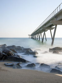 Pier over sea against clear sky