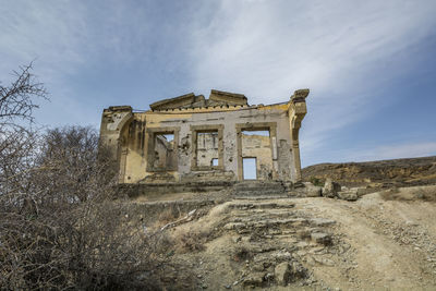 Low angle view of old ruin against sky