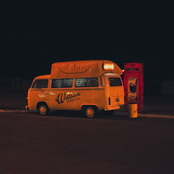 Red toy car on road against sky at night