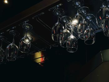 Low angle view of illuminated pendant lights hanging from ceiling