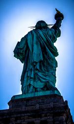 Low angle view of statue against clear blue sky