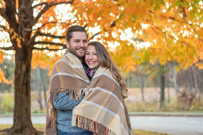 Portrait of a smiling young couple during autumn