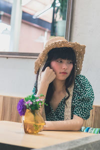 Thoughtful young woman sitting in restaurant 