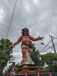 Low angle view of statue against sky