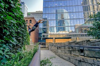 Man standing by modern buildings in city