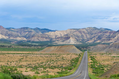 Scenic view of road amidst landscape against sky
