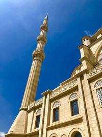 Low angle view of historical building against blue sky