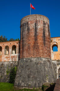 Low angle view of historical building against blue sky