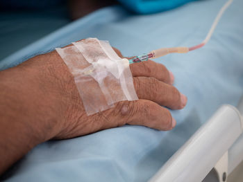 Close-up of man with iv drip at hospital