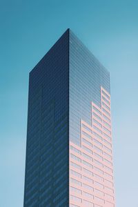 Low angle view of modern building against clear blue sky