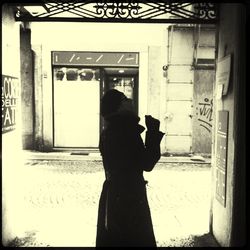 Woman standing against wall