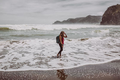 Side view of woman walking at beach