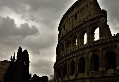 Low angle view of historical building against cloudy sky