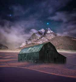 Scenic view of snowcapped mountains against sky at night