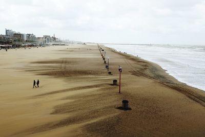 Scenic view of beach against sky in city