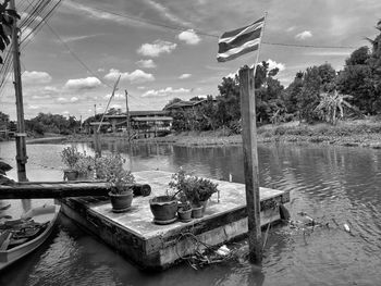 Sailboats moored in lake against sky