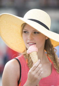 Woman looking away while having ice cream