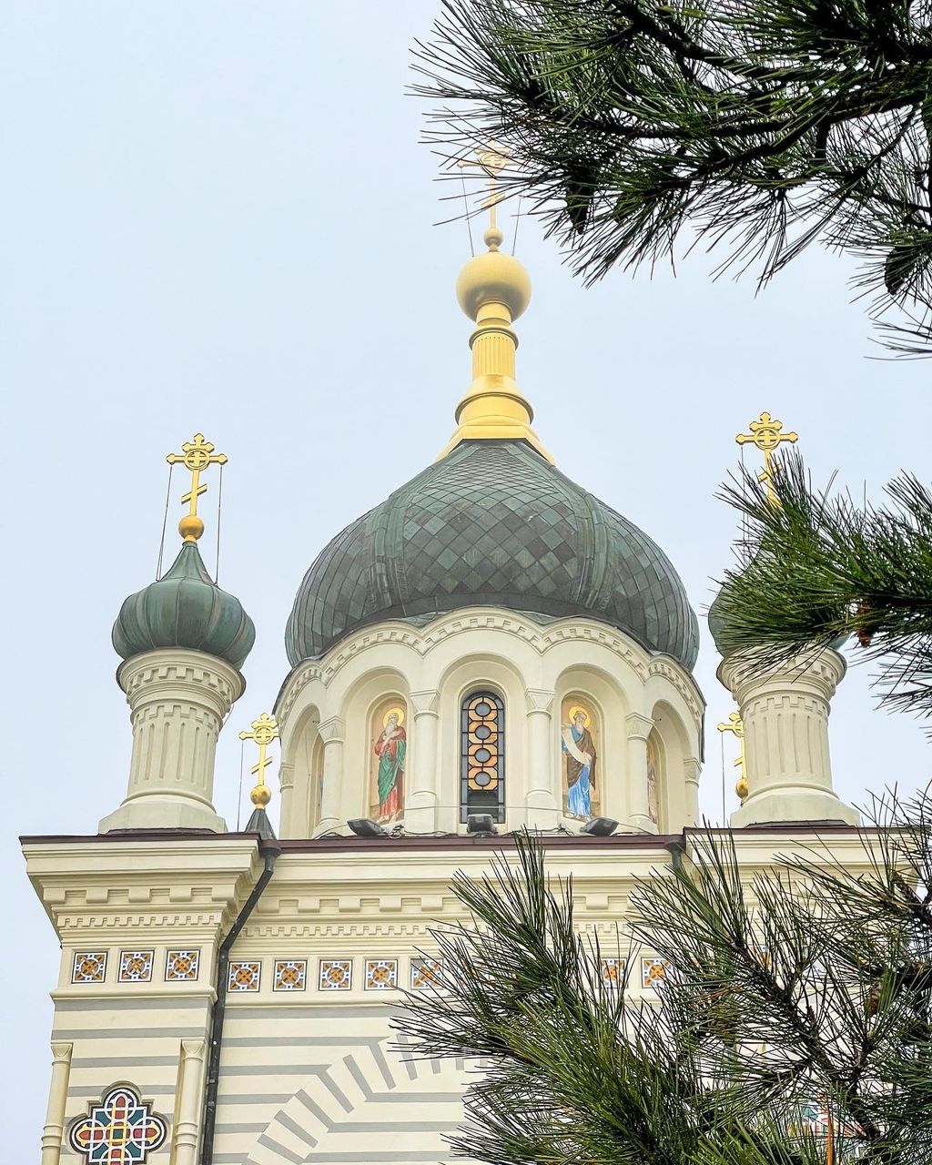 architecture, religion, belief, building exterior, dome, built structure, tree, place of worship, spirituality, travel destinations, nature, plant, building, sky, no people, travel, palm tree, history, the past, day, outdoors, landmark, catholicism, low angle view, clear sky, tourism, tropical climate, tradition, city