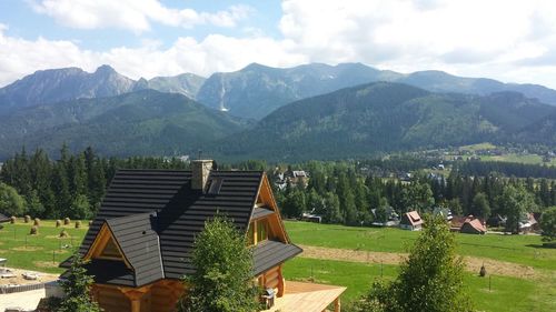 Scenic view of trees and mountains against sky