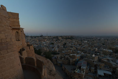 View of buildings in city against clear sky