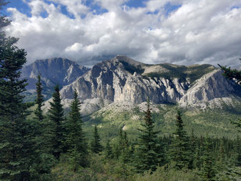 Scenic view of mountains against cloudy sky