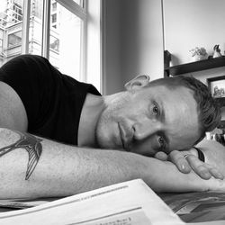 Portrait of man lying down at home