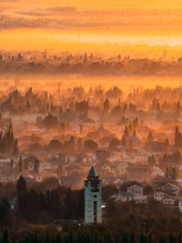 View of buildings in city during sunset