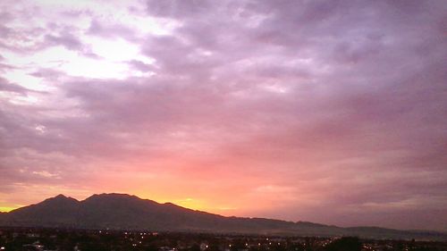 Scenic view of mountains against sky at sunset