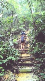 Full length of woman standing in forest