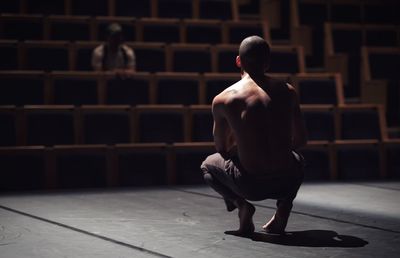 Full length of man sitting on floor