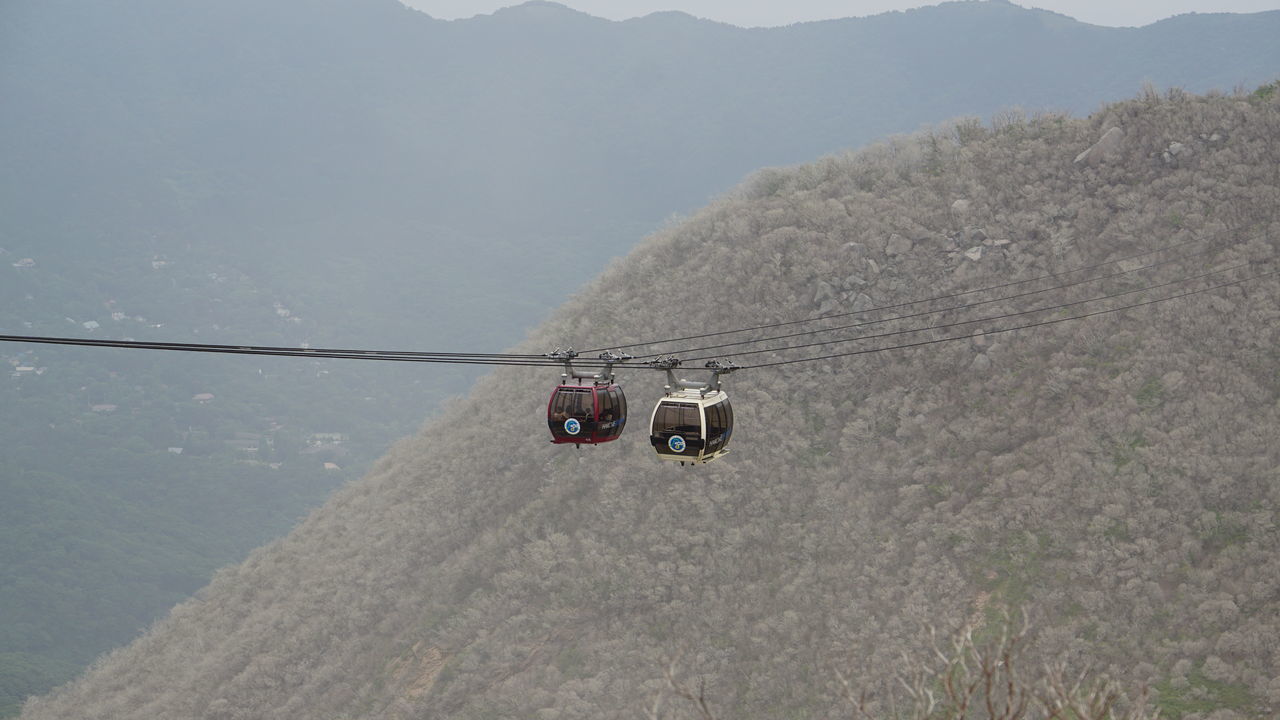 mountain, nature, transportation, day, landscape, scenics, high angle view, no people, beauty in nature, mountain range, outdoors, tranquil scene, tranquility, overhead cable car, sky, ski lift