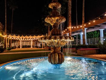 Fountain in swimming pool at night