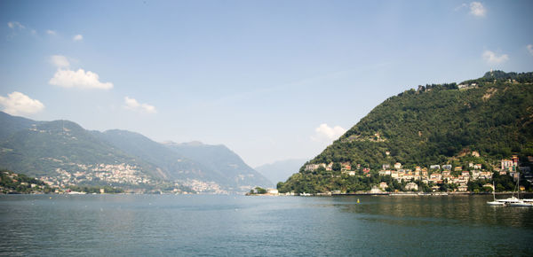 Scenic view of sea and mountains against sky